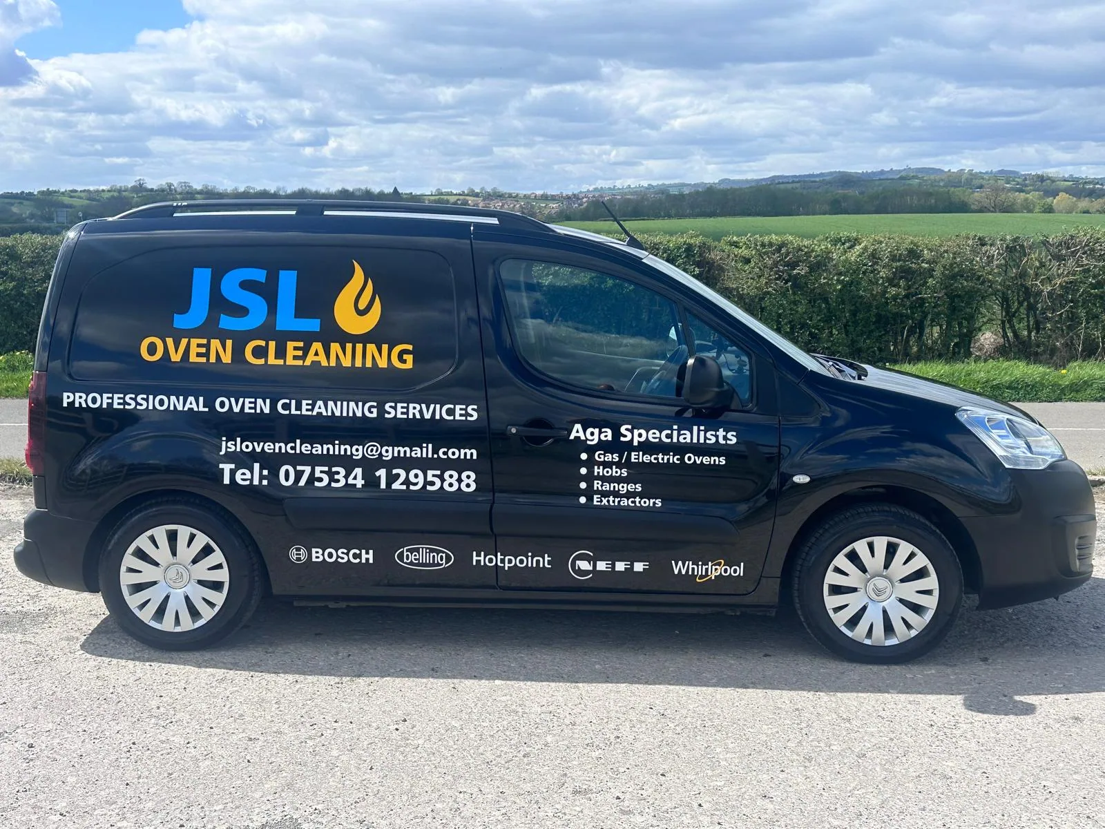 JSL Oven Cleaning van parked with countryside behind it